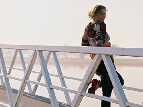 Woman looking over the bridge